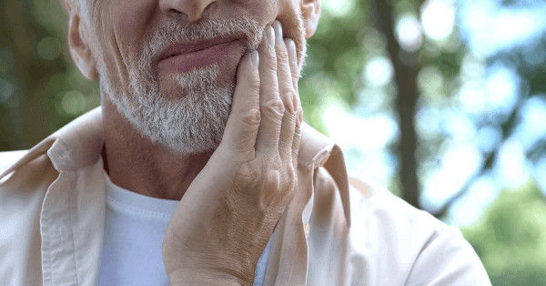 Man in pain after breaking his dental implant