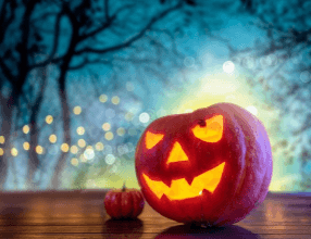 a carved lit up pumpkin outside